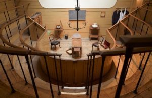 View of stage from top of semi-circular seating, with high wooden rails at The Old Operating Theatre.