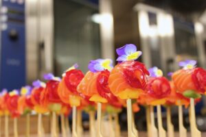 Display of spherical, lollipop-style salmon gravalax canapés
